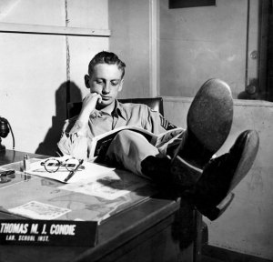 Tom Condie with his legs on a desk in a military office.